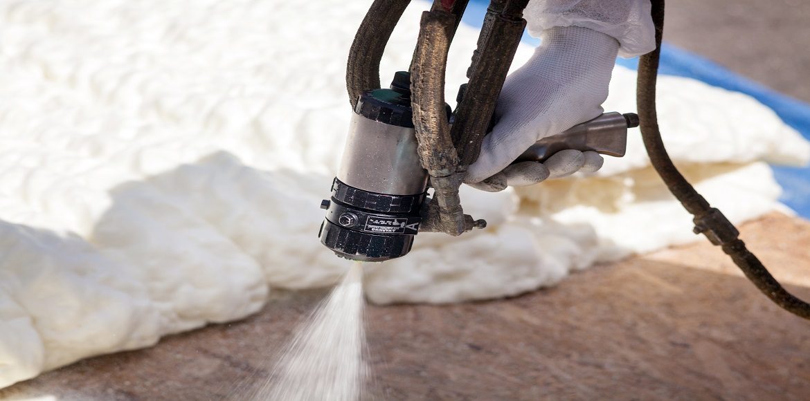 Certified applicator spraying closed-cell foam in an attic in New Jersey